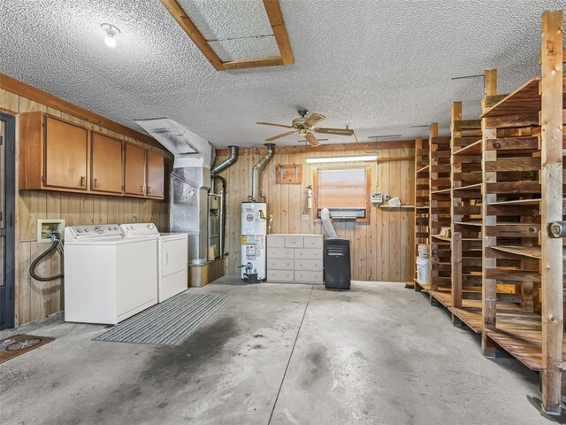 garage featuring ceiling fan, water heater, and wood walls