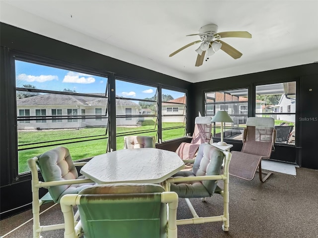 sunroom featuring ceiling fan