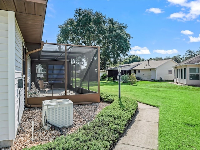 view of yard featuring a lanai and central air condition unit