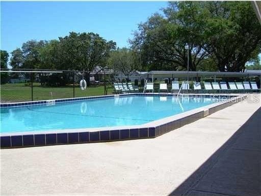 view of pool with a yard