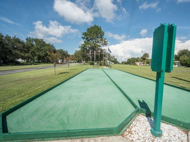 view of home's community with a yard