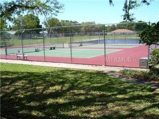 view of sport court with a yard