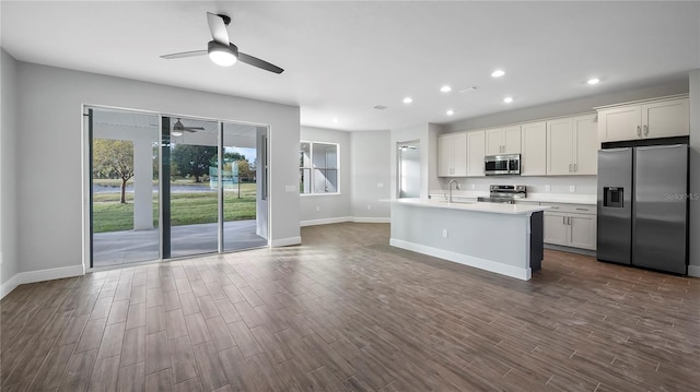 kitchen with white cabinetry, stainless steel appliances, sink, and dark hardwood / wood-style flooring