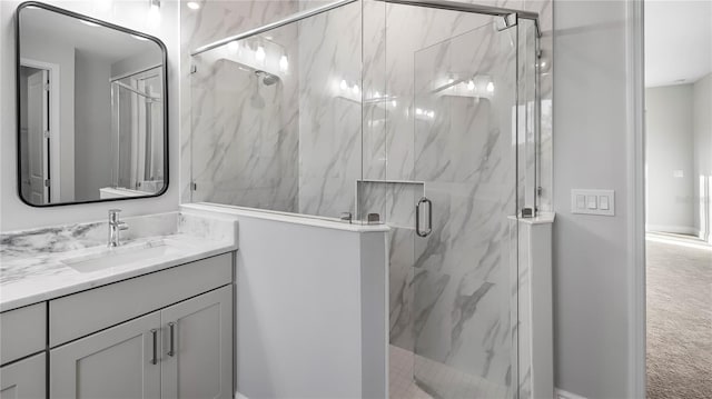 bathroom with vanity and a shower with door