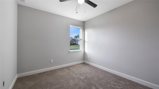 spare room with ceiling fan, vaulted ceiling, and carpet