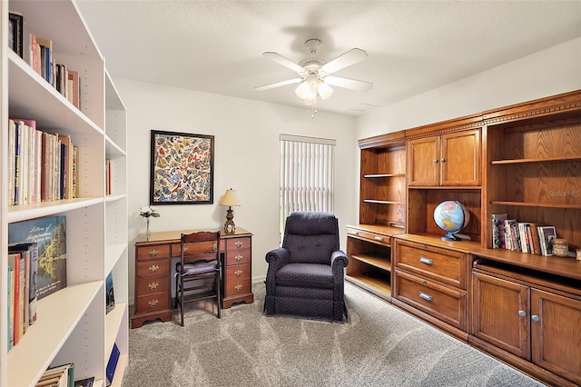 living area with ceiling fan and light colored carpet