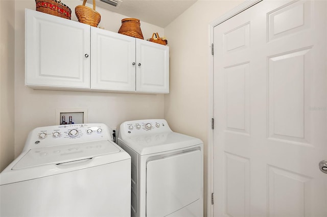 laundry area with cabinets and washer and clothes dryer