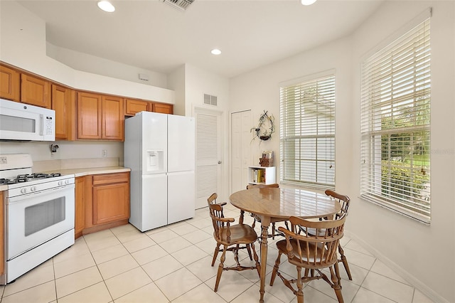 kitchen with light tile patterned floors and white appliances