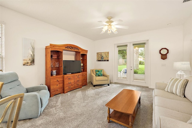 living room featuring light carpet and ceiling fan