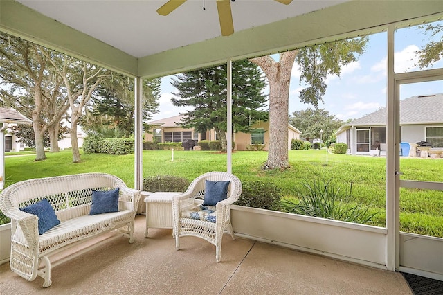 sunroom featuring ceiling fan