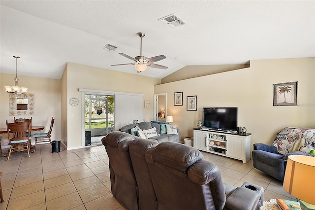 tiled living room featuring vaulted ceiling and ceiling fan with notable chandelier