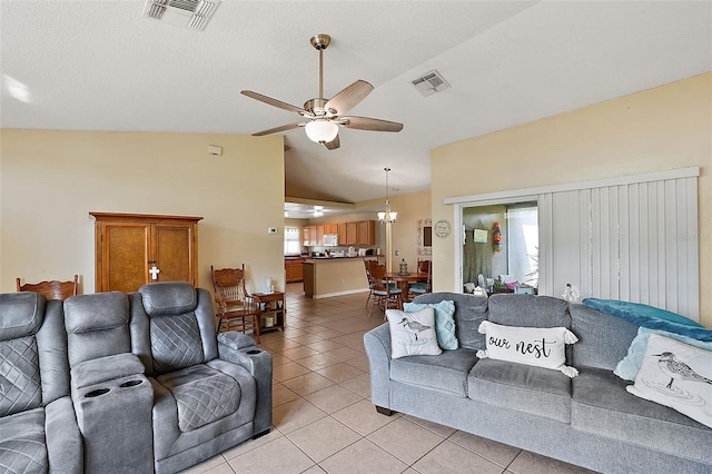 living room featuring ceiling fan, light tile patterned floors, and vaulted ceiling