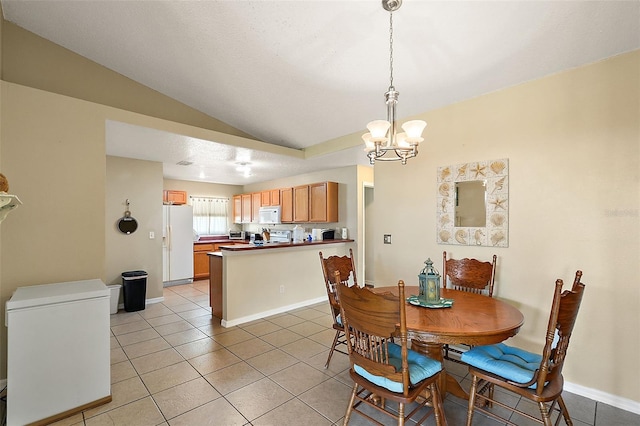 tiled dining space with lofted ceiling and an inviting chandelier