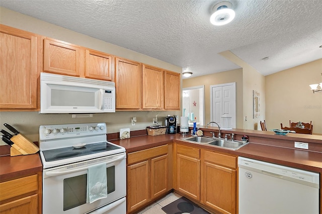 kitchen with kitchen peninsula, a textured ceiling, white appliances, sink, and light tile patterned floors