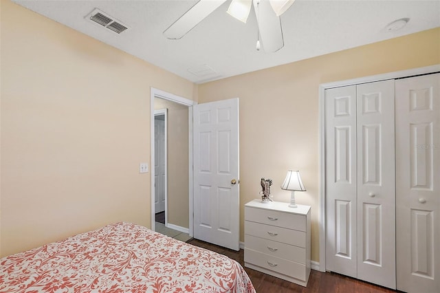 bedroom with dark hardwood / wood-style floors, a closet, and ceiling fan