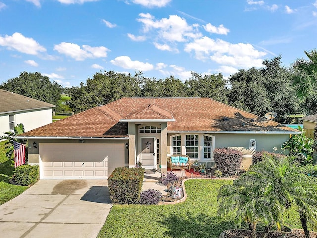 view of front of house featuring a garage and a front yard