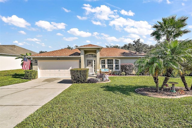 mediterranean / spanish house featuring a front yard and a garage