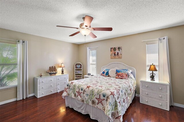 bedroom featuring ceiling fan, dark hardwood / wood-style floors, and a textured ceiling