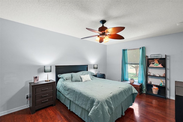 bedroom featuring ceiling fan, dark hardwood / wood-style flooring, and a textured ceiling