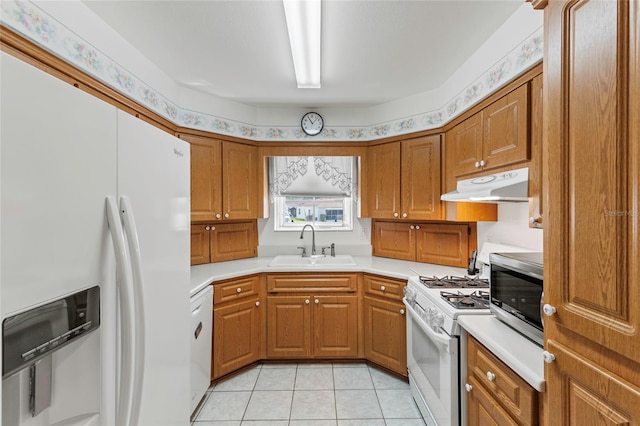 kitchen with white appliances, light tile patterned floors, and sink