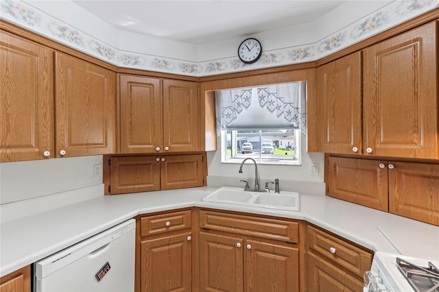 kitchen featuring dishwasher, stainless steel range, and sink