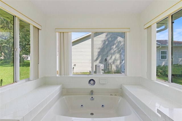 bathroom with tiled bath and a wealth of natural light