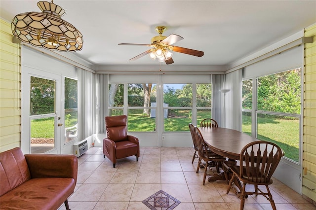 sunroom featuring ceiling fan and a healthy amount of sunlight