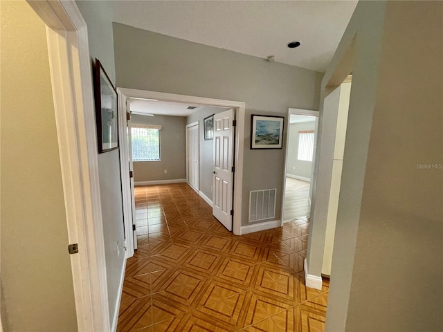 hall with light tile patterned floors