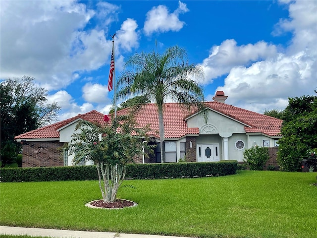 mediterranean / spanish-style home featuring a front yard