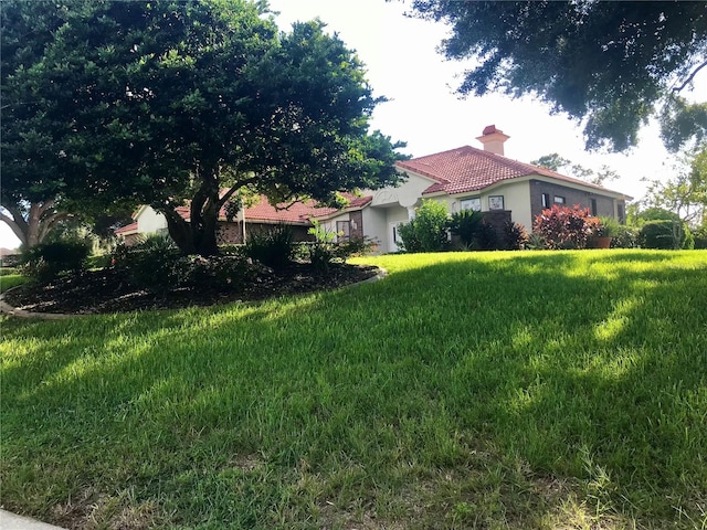 mediterranean / spanish-style house featuring a front yard