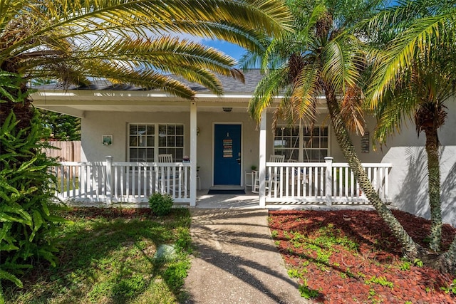 view of exterior entry featuring a porch