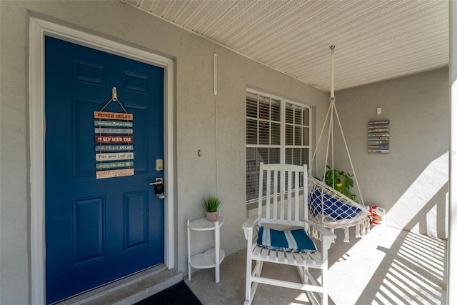 view of exterior entry with covered porch