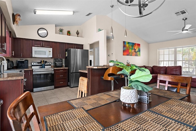 interior space featuring ceiling fan with notable chandelier, sink, and high vaulted ceiling