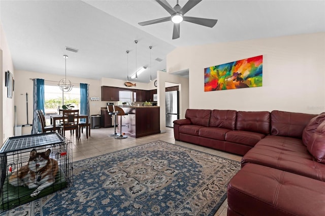 living room with light tile patterned floors, vaulted ceiling, and ceiling fan