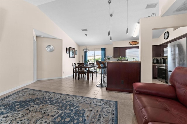 living room featuring light tile patterned floors and high vaulted ceiling