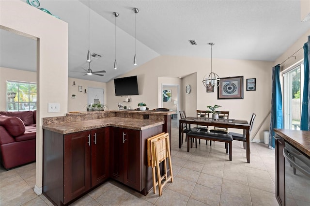 kitchen featuring ceiling fan, light tile patterned floors, decorative light fixtures, dishwasher, and vaulted ceiling