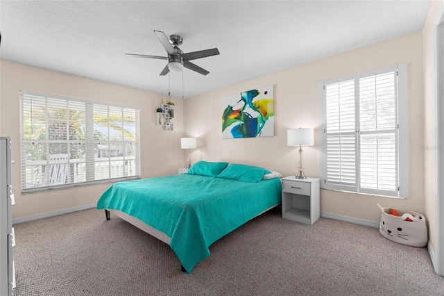 bedroom with ceiling fan and carpet flooring