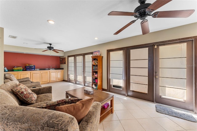 living room featuring light tile patterned flooring, sink, and french doors