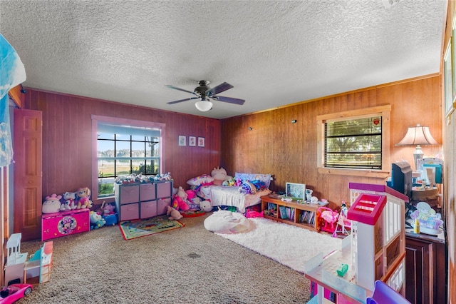 bedroom with carpet, a textured ceiling, multiple windows, and ceiling fan