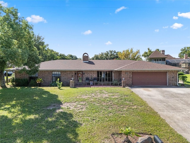 single story home featuring a garage and a front lawn