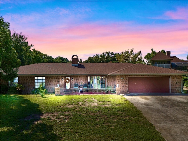 single story home with a yard and a garage