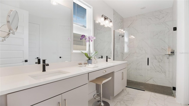 bathroom featuring a shower with door and vanity