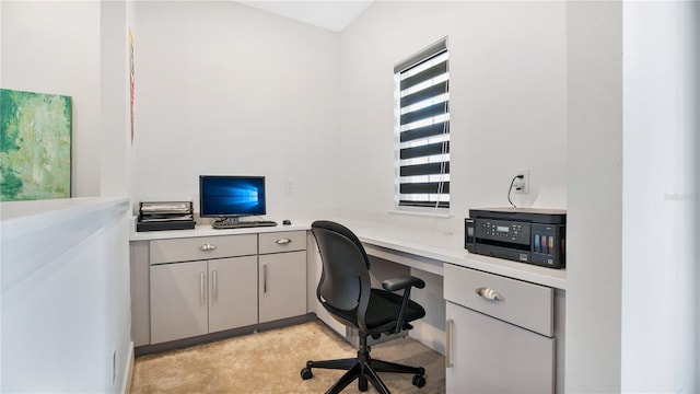 carpeted office with built in desk