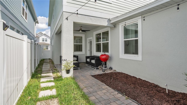 exterior space with ceiling fan