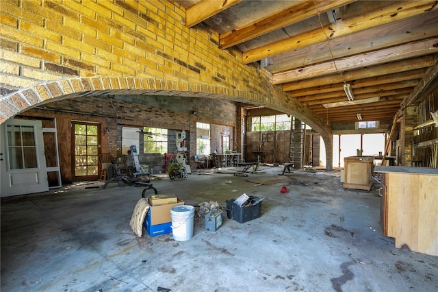 misc room featuring brick wall and plenty of natural light