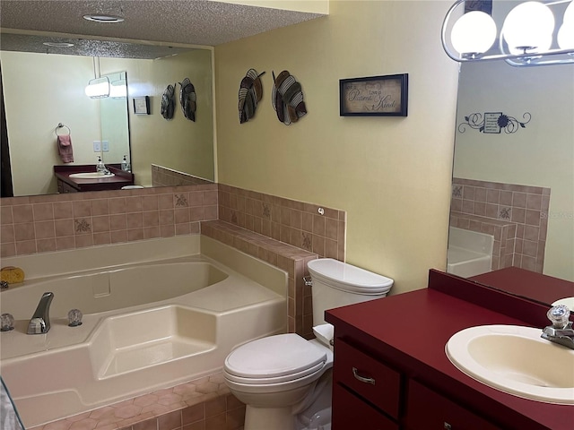 bathroom with vanity, a tub, a textured ceiling, tile patterned floors, and toilet