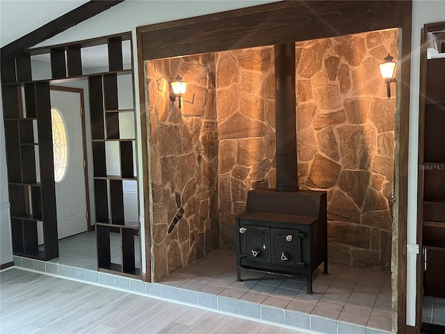 room details with hardwood / wood-style floors and a wood stove