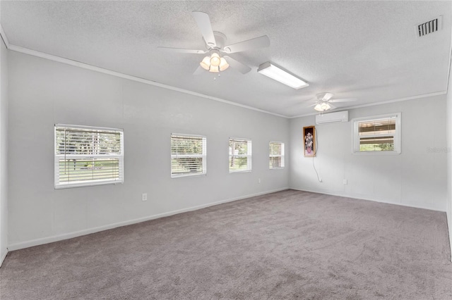 carpeted empty room featuring ceiling fan, ornamental molding, and a wealth of natural light