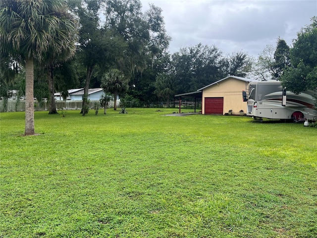 view of yard with a garage and an outdoor structure