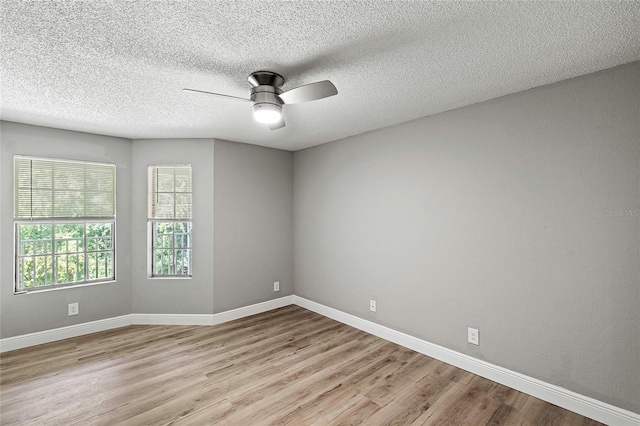 spare room featuring ceiling fan, a textured ceiling, and light wood-type flooring